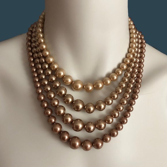 Four strand graduating beaded necklace in taupe to light gold tone